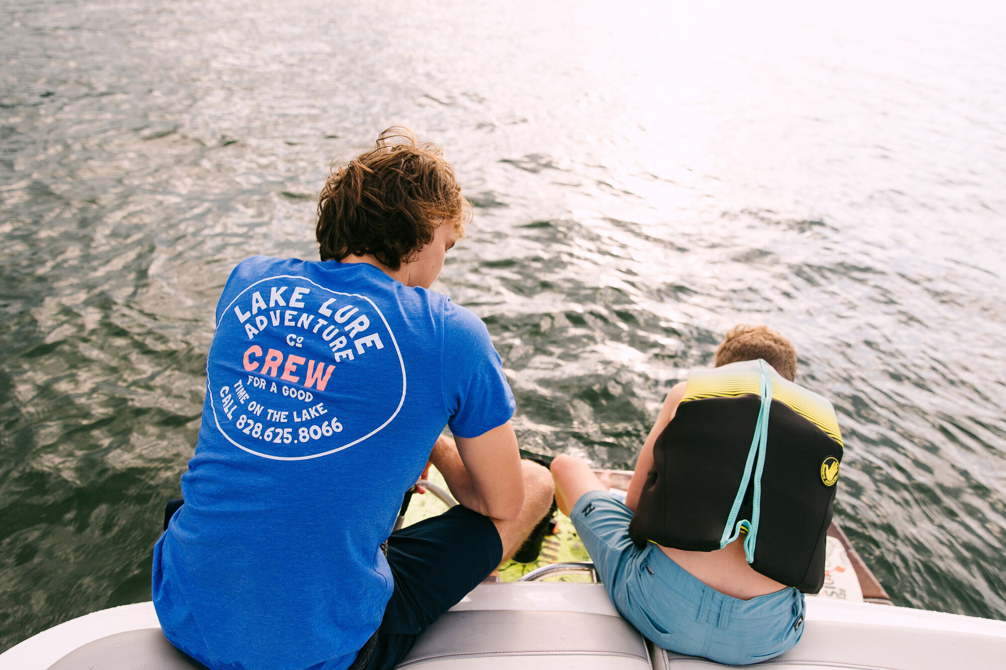 A Lake Lure Adventure instructor coaching from the boat